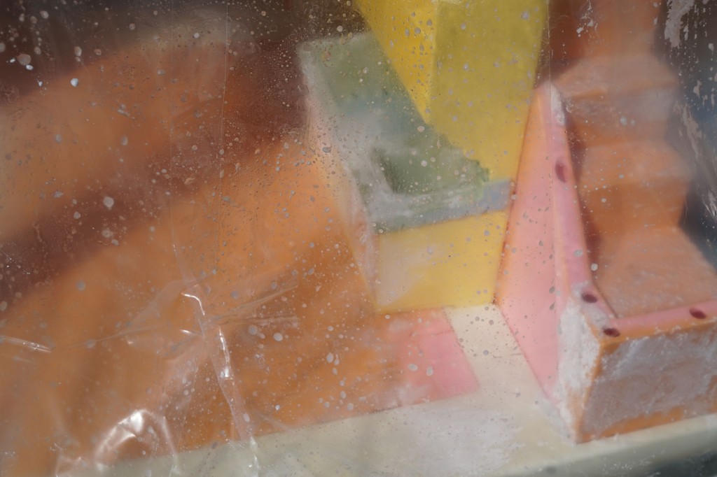 Victorian Playskool Dollhouse covered with plastic to bleach in the sun